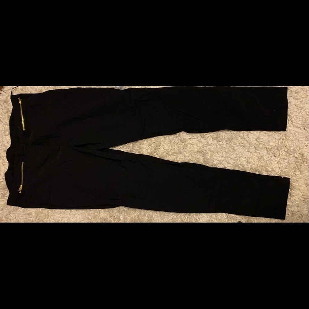 Black trousers gold zippers